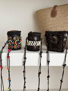 Detail view of handmade Bohemian coconut shell pouch necklaces with colorful beads