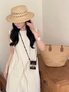 Bohemian style coconut shell mini purse necklace worn by model in a natural setting