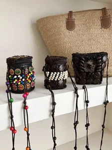 Handmade bohemian coconut shell pouch necklaces with colorful beads and long cords.
