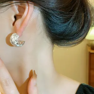 Elegantes pendientes plateados en forma de C con diseño de textura cruzada único
