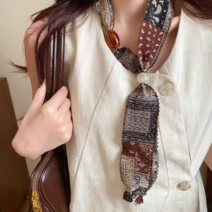 Close-up of patterned fabric necklace texture with amber bead and large pearl details
