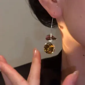 Detailed close-up of a vintage style geometric ear hook featuring a champagne rhinestone