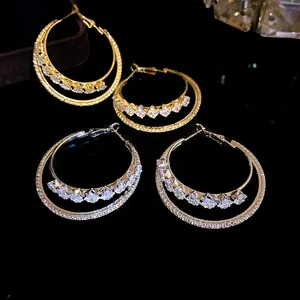 Detailed view of 18k gold plated and silver double-layer hoop earrings with zircons
