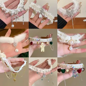 Multiple styles of white plush chokers with sparkling rhinestone charms and pearls for winter.