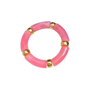 Chic pink marbled acrylic tube bracelet with polished gold spacers for elegant style