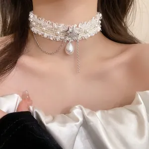 Close-up of white furry choker necklace with pearl drop and star pendant