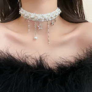 Close-up of a white fuzzy choker necklace featuring rhinestone star and pearl charms