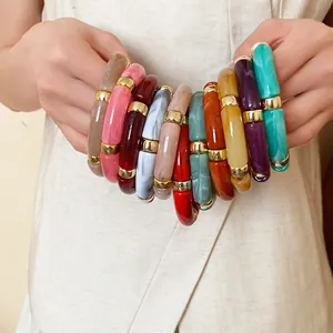 Close-up of colorful marbled acrylic bracelets with gold-tone spacers