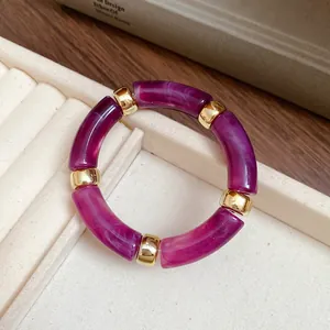 Detailed close-up of a purple marbled acrylic bracelet with elegant gold spacers