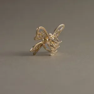 Elegant hollow butterfly gold hair claw clip with intricate iris floral design for women
