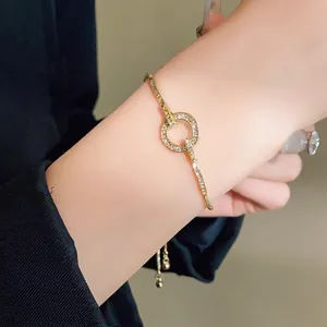 Elegant gold-tone adjustable bracelet with sparkling rhinestone circle charm for women