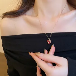 Elegant rose gold necklace with red enamel gourd pendant and sparkling zircon accents