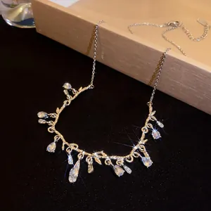 Elegant silver-toned branch necklace with sparkling teardrop crystals for women.