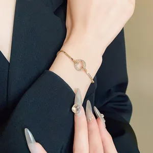 Detailed close-up of a sparkling rhinestone circular adjustable bracelet in gold