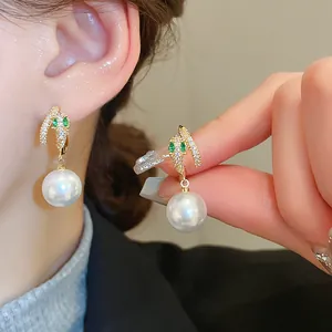 Elegant S-shaped earrings decorated with zircon and a hanging white faux pearl pendant