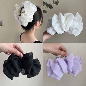 Large mesh hair claw clip with oversized ruffle fabric bow design for women's hairstyle