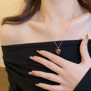 Elegant close-up of a red gourd zircon necklace worn on a woman's graceful collarbone