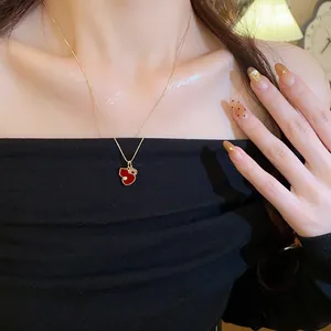 Elegant red enamel gourd pendant necklace with zircon shown on a female model neck