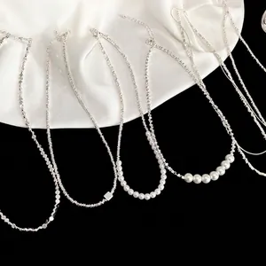 Collection of elegant silver-colored pearl necklaces with unique niche designs for women