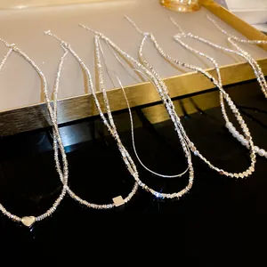 Collection of minimalist silver-tone necklaces with heart, square pendants and pearls