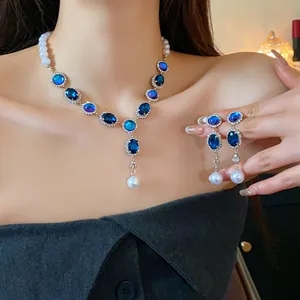 Detailed close-up of a French vintage jewelry set featuring blue crystals and pearls.