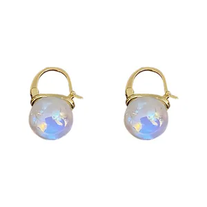 Elegant mermaid iridescent pearl hoop earrings with gold finish for a vintage chic look.