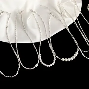 Detailed collection of minimalist silver necklaces with pearls on white and black background
