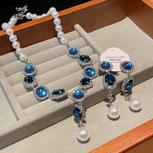 Elegant French vintage necklace and earrings set with blue crystals and pearls.