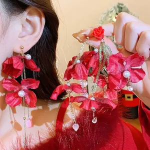 Handmade red fabric flower earrings with pearls and long gold tassels for festive occasions