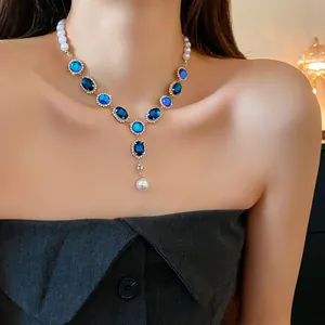 Elegant French vintage necklace featuring blue oval gemstones and white pearls on model.