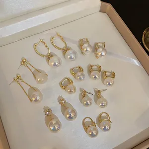 Collection of vintage iridescent mermaid pearl earrings with gold-tone settings.