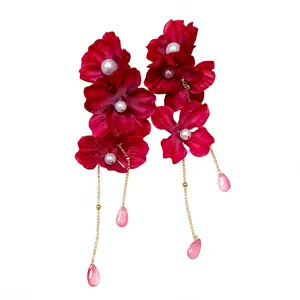 Elegant red fabric flower earrings with white pearls and long gold chain tassels