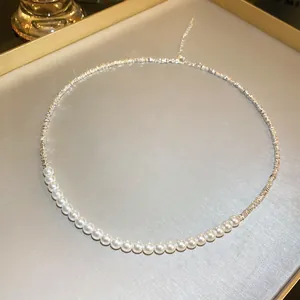 Close-up detail of an elegant pearl and textured silver chain necklace for women jewelry
