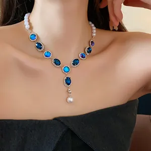 Elegant French vintage necklace with blue oval gemstones, pearls, and crystal tassels for women