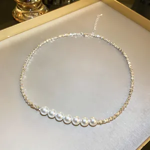 Macro shot of elegant necklace featuring white pearls and faceted silver beads