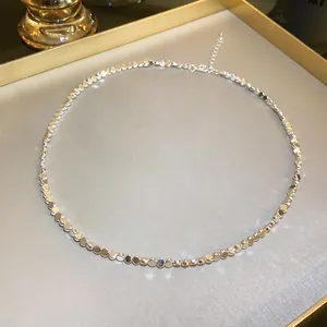 Close-up view of a minimalist silver metallic disc necklace with adjustable chain detail