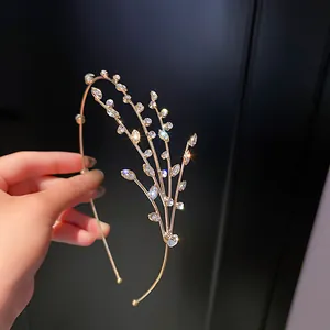 Detailed macro view of a sparkling gold rhinestone branch headband fashion hair accessory