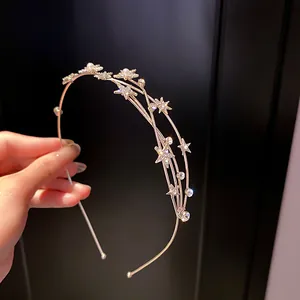 Close-up of elegant star and pearl rhinestone headband with a refined metallic finish