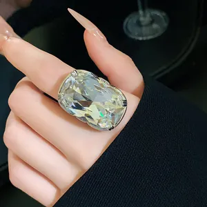 Close-up of a stunning oversized faceted crystal ring on index finger with a silver band.