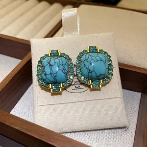 Vintage gold plated stud earrings with faux turquoise stone and blue crystal accents
