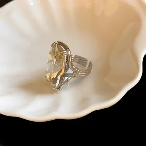 Detail view of oversized marquise cut crystal ring with silver adjustable band.