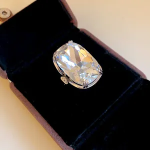 Close-up of an exaggerated cushion-cut large stone ring presented in a velvet box