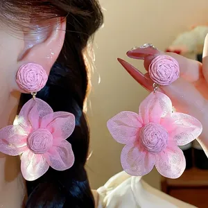 Elegant pink chiffon flower earrings with a woven raffia center for a charming sweet look