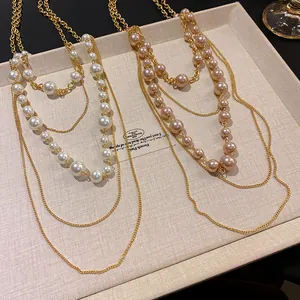 Detalle de collares de capas retro con perlas elegantes y cadenas doradas