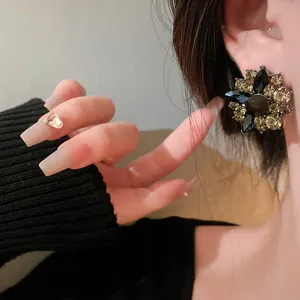Close-up of vintage flower crystal stud earrings showing intricate rhinestone details