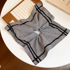 Oversized black and white checkered square scrunchie for stylish ponytail hair styling