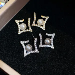 Elegant geometric rhombus stud earrings with sparkling cubic zirconia and round pearls.