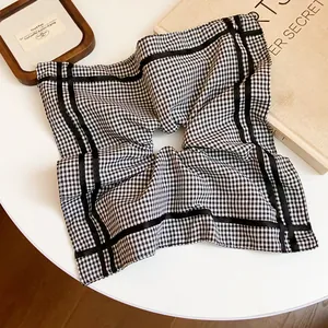 Close-up of black and white checkered square scrunchie hair tie hair accessory