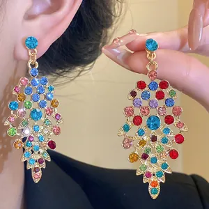 Close-up of vibrant multicolored rhinestone leaf tassel earrings in vintage palace style
