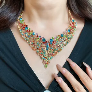 Detailed macro view of colorful vintage crystal leaf tassel necklace worn by an Asian model